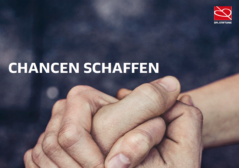 The photo shows two interlocked hands on a dark gray background and the words "Creating opportunities".